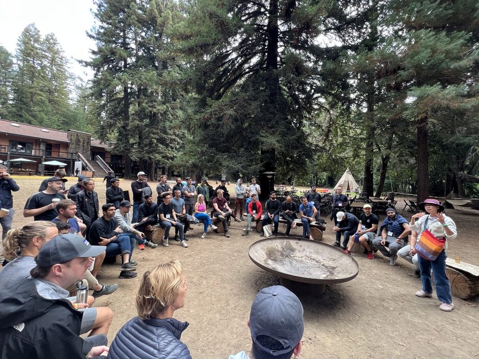 Circle of founders sitting around a fire pit during an unconference session